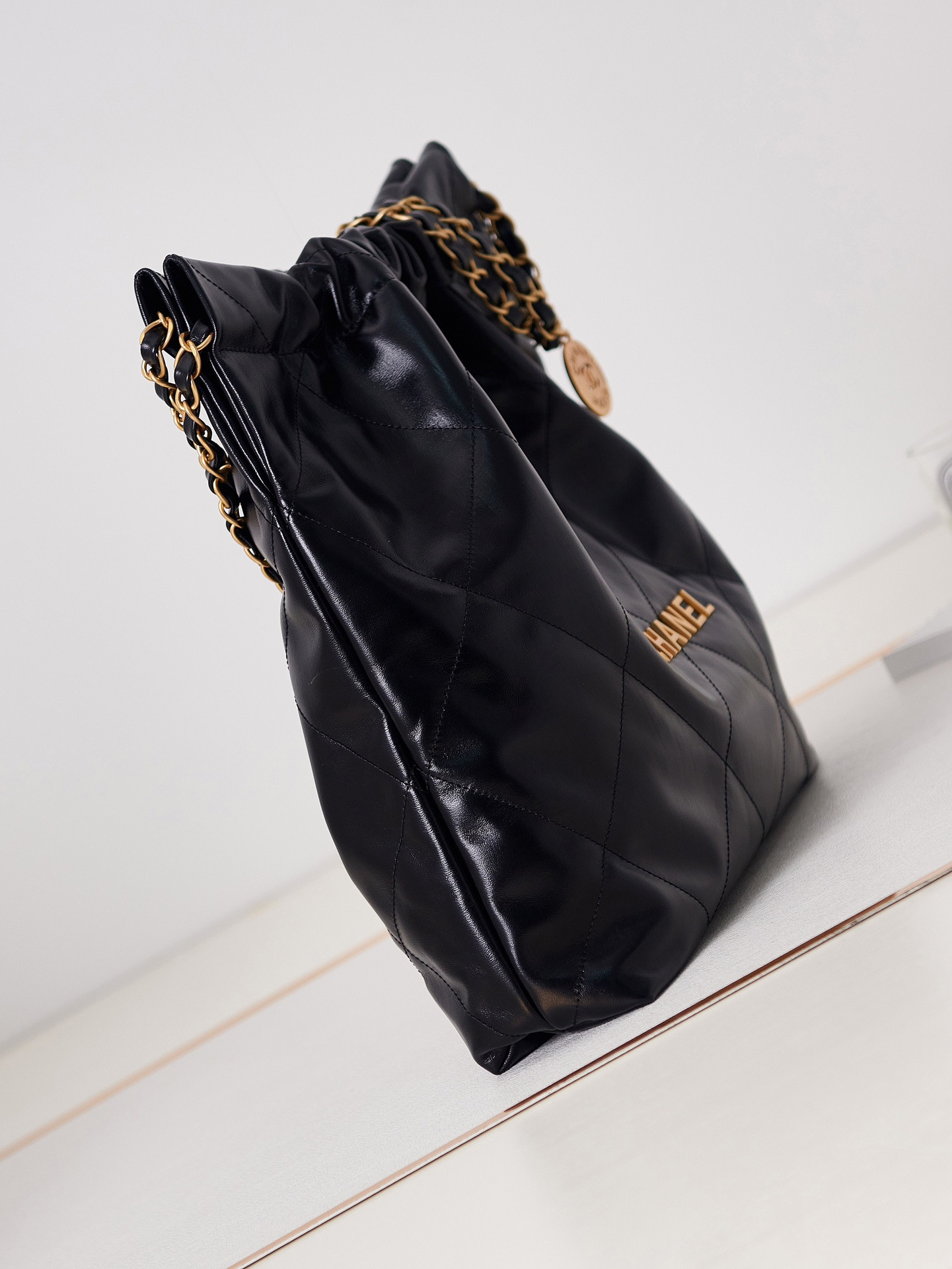 Ch*el 22 handbag shiny calfskin & gold-tone metal black 15.2×16.4×3.1 in